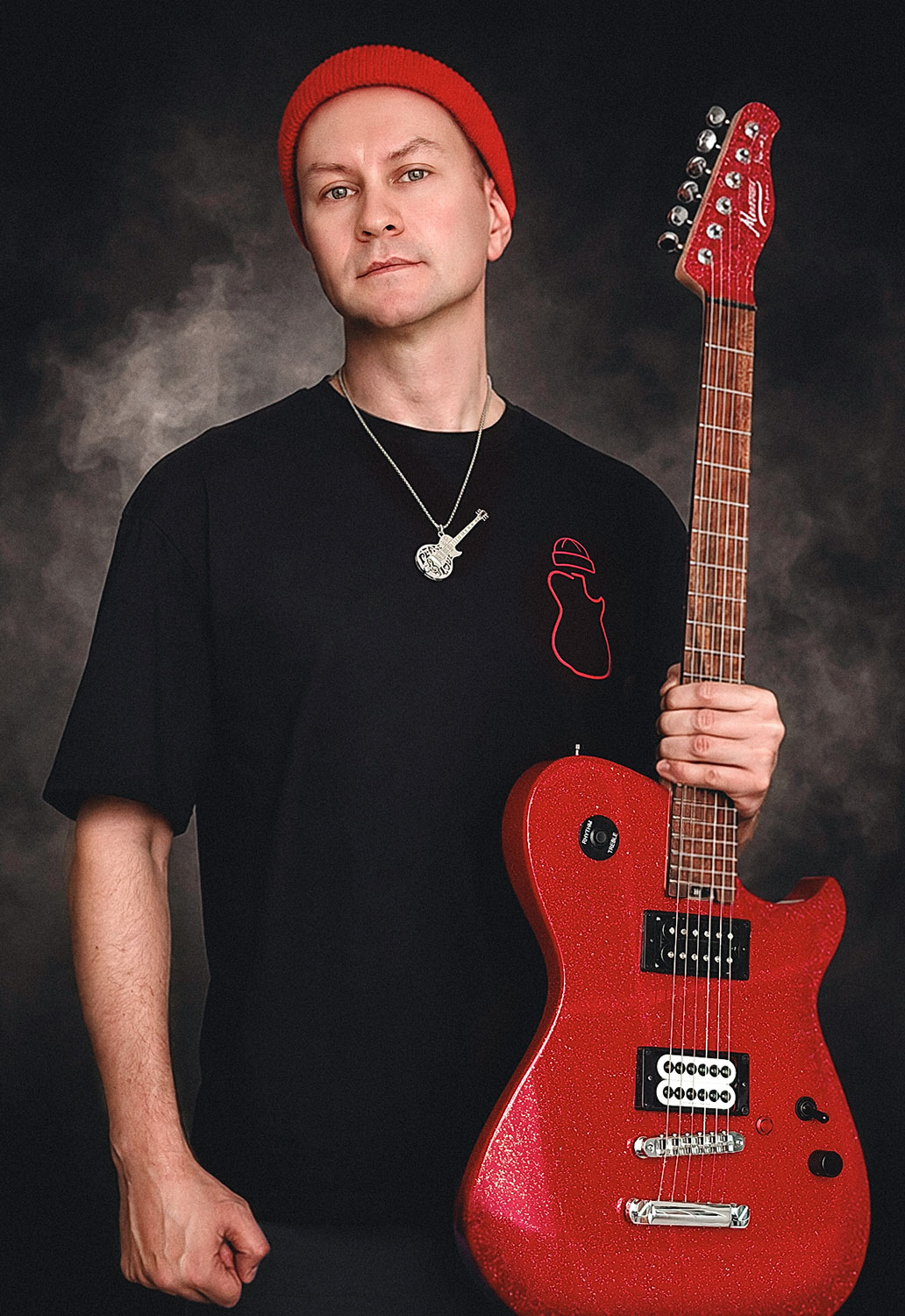 Andrew Nitsievsky holding a red electric guitar