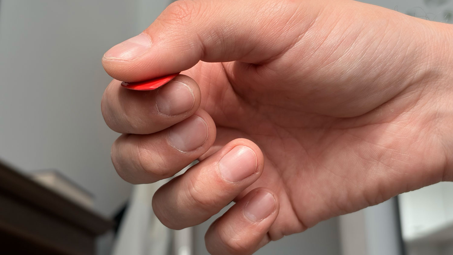Locked and tense picking hand with a compressed wrist