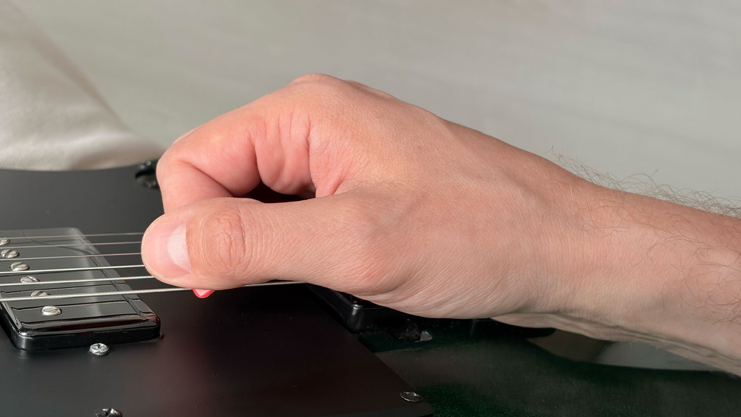 Top view of picking hand showing pick exposure and bridge position